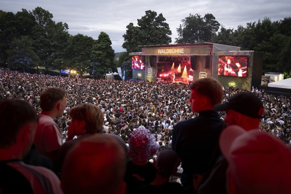 epa12241946 Festivalgoers listen to the concert of Swiss rapper Luc Julian Peyer also know as Jule X on the Waldbuehne Stage at the 42nd edition of the Gurtenfestival in Bern, Switzerland, 16 July 202 ...
