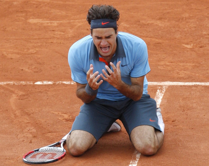 Switzerland&#039;s Roger Federer jubilates after defeating Sweden&#039;s Robin Soderling during their men&#039;s singles final match of the French Open tennis tournament at the Roland Garros stadium i ...