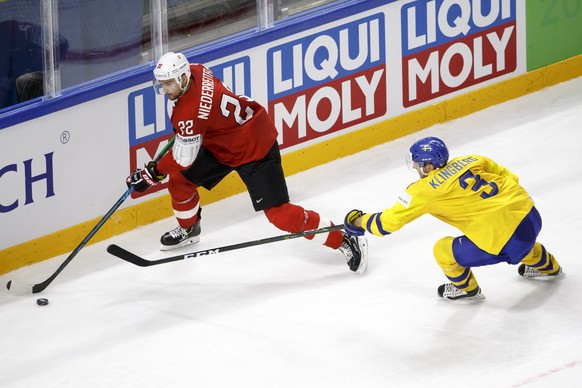 Switzerland&#039;s forward Nino Niederreiter, left, vies for the puck with Sweden&#039;s defender John Klingberg, right, during the IIHF 2018 World Championship preliminary round game between Switzerl ...