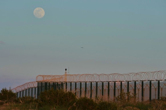 The moon rises over the fences of U.K.'s RAF Akrotiri air base after it was hit by a drone strike early morning near Limassol, Cyprus, Monday, March, 2, 2026. (AP Photo/Petros Karadjias)
Cyprus I ...