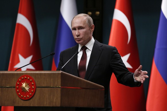 epa06643792 Turkish President Recep Tayyip Erdogan (not in picture) and Russian President Vladimir Putin during a press conference after their meeting at the Presidential Palace in Ankara, Turkey 03 A ...