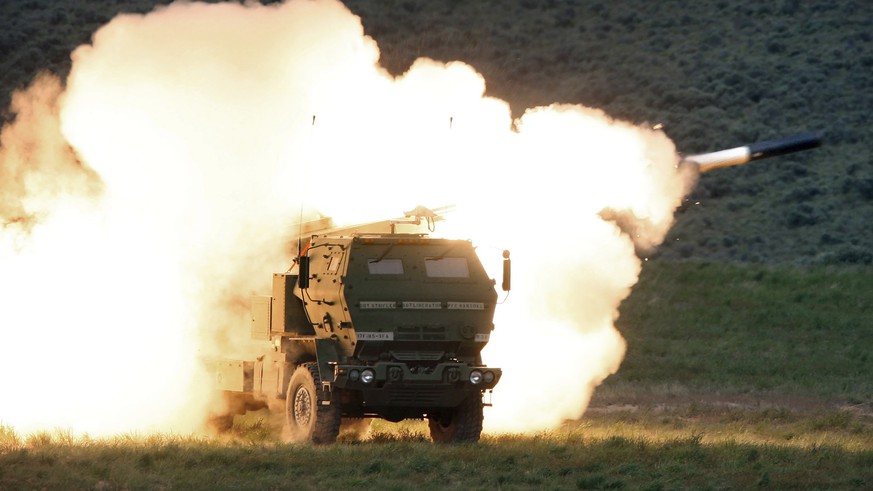 FILE - In this May 23, 2011, file photo a launch truck fires the High Mobility Artillery Rocket System (HIMARS) produced by Lockheed Martin during combat training in the high desert of the Yakima Trai ...