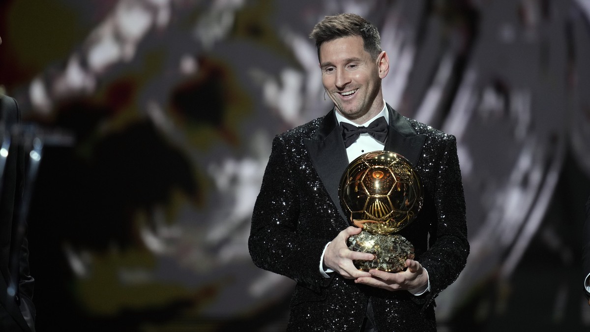 PSG player Lionel Messi reacts after winning the 2021 Ballon d'Or trophy during the 65th Ballon d'Or ceremony at Theatre du Chatelet, in Paris, Monday, Nov. 29, 2021. Messi won the Ballon d& ...