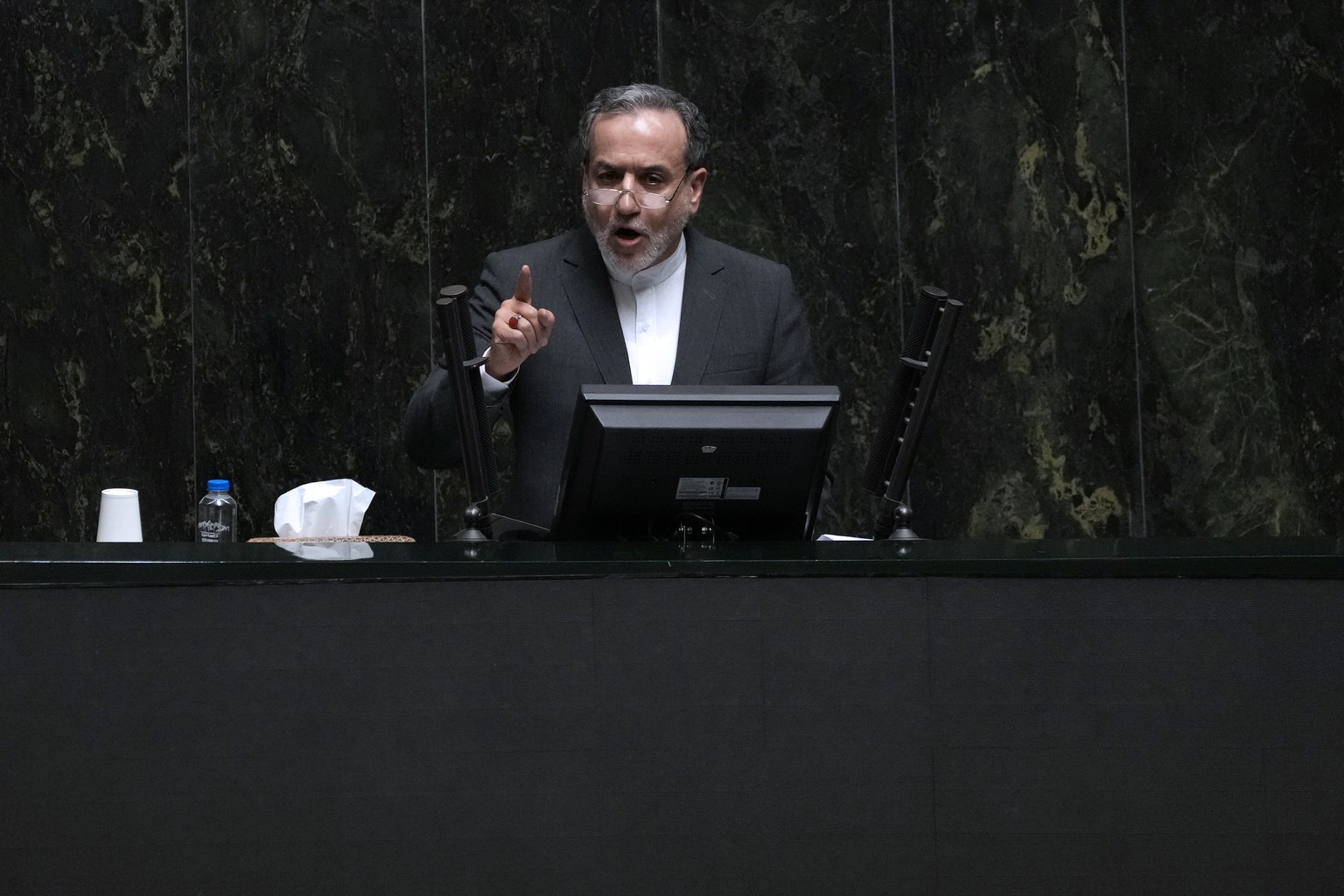 Nominee for foreign minister Abbas Araghchi speaks in an open session of parliament during the second day of debate on the 19 proposed ministers by Iranian President Masoud Pezeshkian in Tehran, Iran, ...