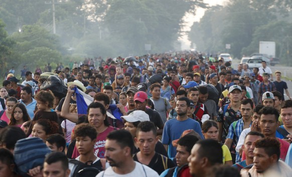 Central American migrants walking to the U.S. start their day departing Ciudad Hidalgo, Mexico, Sunday, Oct. 21, 2018. Despite Mexican efforts to stop them at the border, about 5,000 Central American  ...