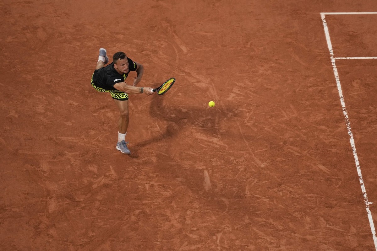 Hungary's Marton Fucsovics plays a shot against Serbia's Novak Djokovic during their second round match of the French Open tennis tournament at the Roland Garros stadium in Paris, Wednesday, ...