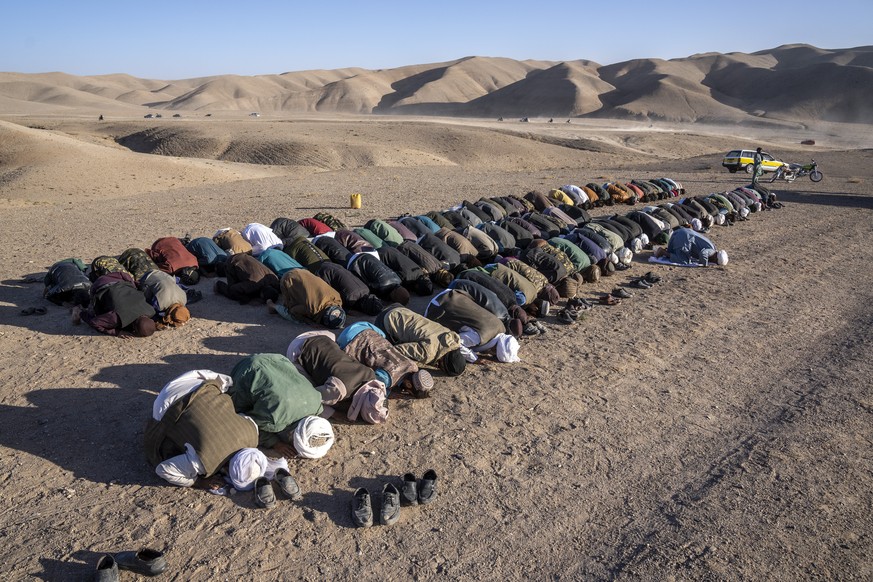 Afghans pray for relatives killed in an earthquake to a burial site after an earthquake in Zenda Jan district in Herat province, western of Afghanistan, Sunday, Oct. 8, 2023. Powerful earthquakes kill ...