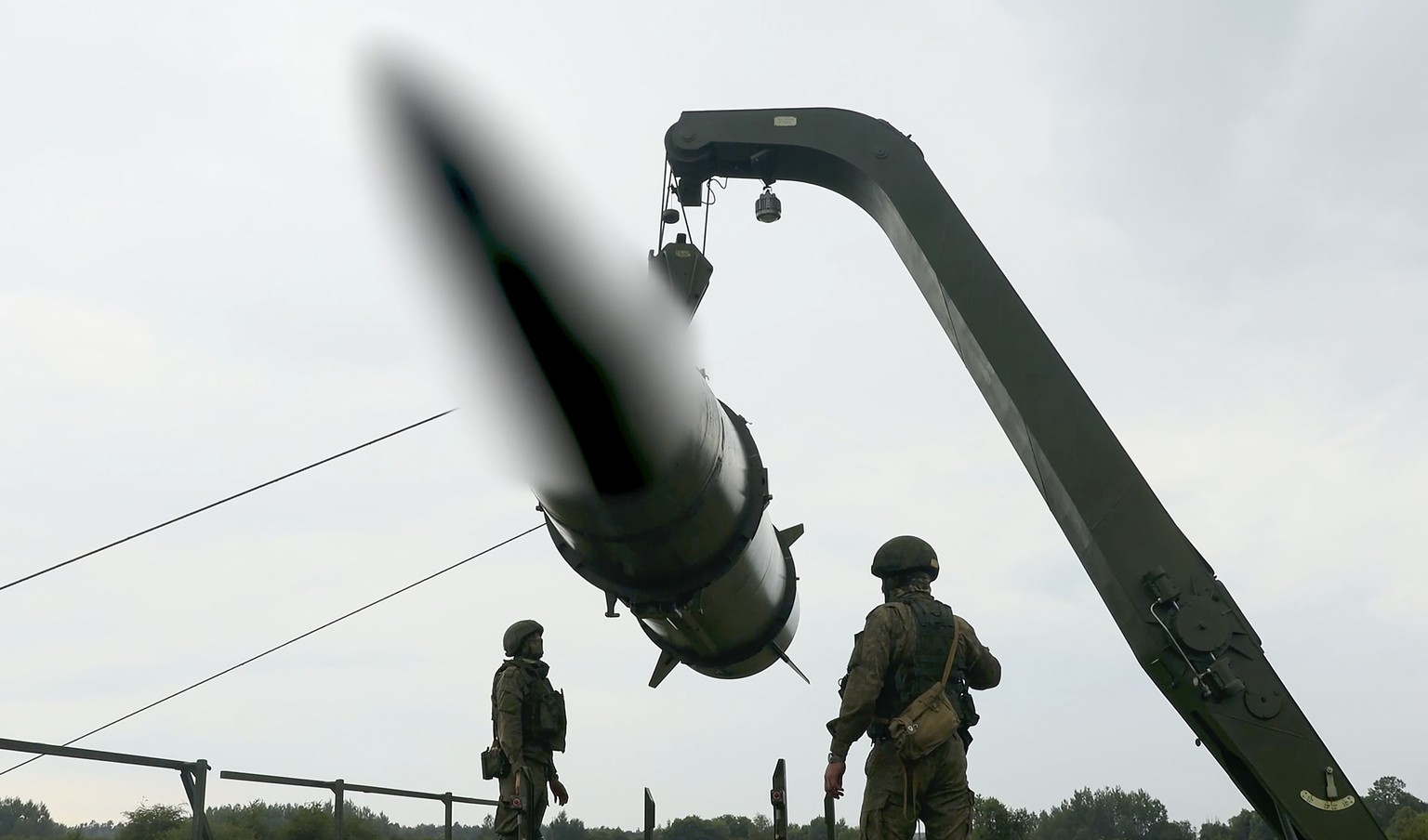 epa11407644 A still image taken from a handout video made available by the Russian Defence Ministry press-service shows Russian servicemen operating a non-strategic nuclear missile for Iskander operat ...
