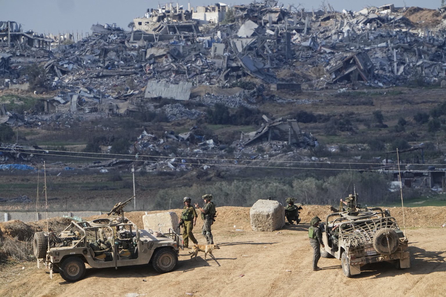 FILE - Israeli soldiers take up positions near the Gaza Strip border, in southern Israel, Friday, Dec. 29, 2023. The army is battling Palestinian militants across Gaza in the war ignited by Hamas&#039 ...