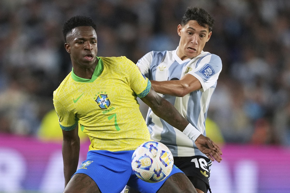 Argentina's Nahuel Molina and Brazil's Vinicius Junior (7) vie for the ball during a World Cup 2026 qualifying soccer match at Monumental Stadium in Buenos Aires, Argentina, Tuesday, March 2 ...