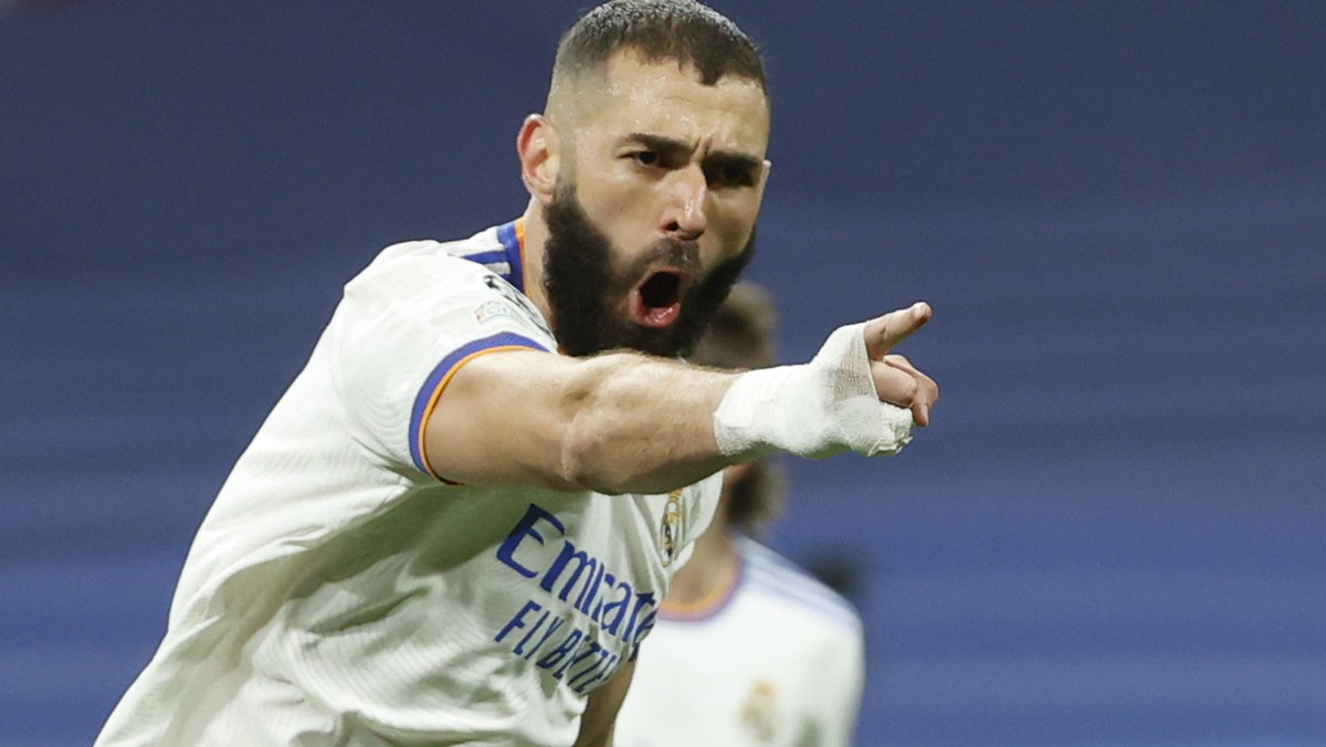 epa09813670 Real Madrid's Karim Benzema celebrates after scoring the 1-1 equalizer during the UEFA Champions League round of 16, second leg soccer match between Real Madrid and Paris Saint-Germai ...