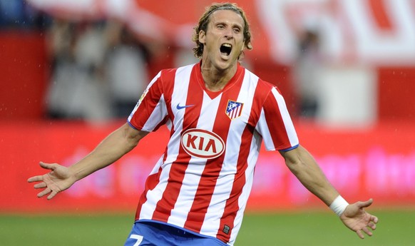 Atletico de Madrid&#039;s Diego Forlan from Uruguay reacts, after his team mate Sergio Leonel Kun Aguero from Argentina scored a goal against Almeria during his Spanish La Liga soccer match at the Vic ...