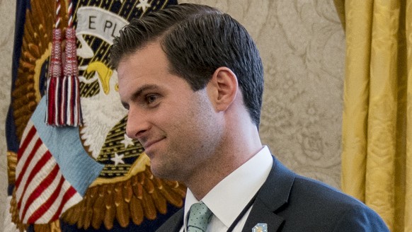 FILE - In this Jan. 31, 2018 file photo, White House aide John McEntee, right, and Treasury Secretary Steve Mnuchin&#039;s Chief of Staff Eli Miller, left, stand in the Oval Office as President Donald ...