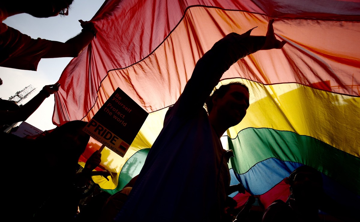epa07000124 (FILE) - Silhouetted members of the LGBT (Lesbian, Gay, Bisexual and Transgender) community wave a rainbow flag during a pride parade, in Bangalore, India, 20 November 2016 (reissued 06 Se ...
