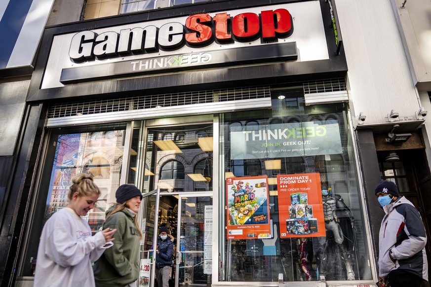 FILE - In this Jan. 28, 2021, file photo, pedestrians pass a GameStop store on 14th Street at Union Square, in the Manhattan borough of New York. The recent GameStop frenzy provided what parents and e ...