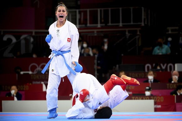 epa09402804 Elena Quirici (L) of Switzerland competes in the women&#039;s karate kumite +61kg fight against Hamideh Abbasali of the Islamic Republic of Iran at the 2020 Tokyo Summer Olympics in Tokyo, ...