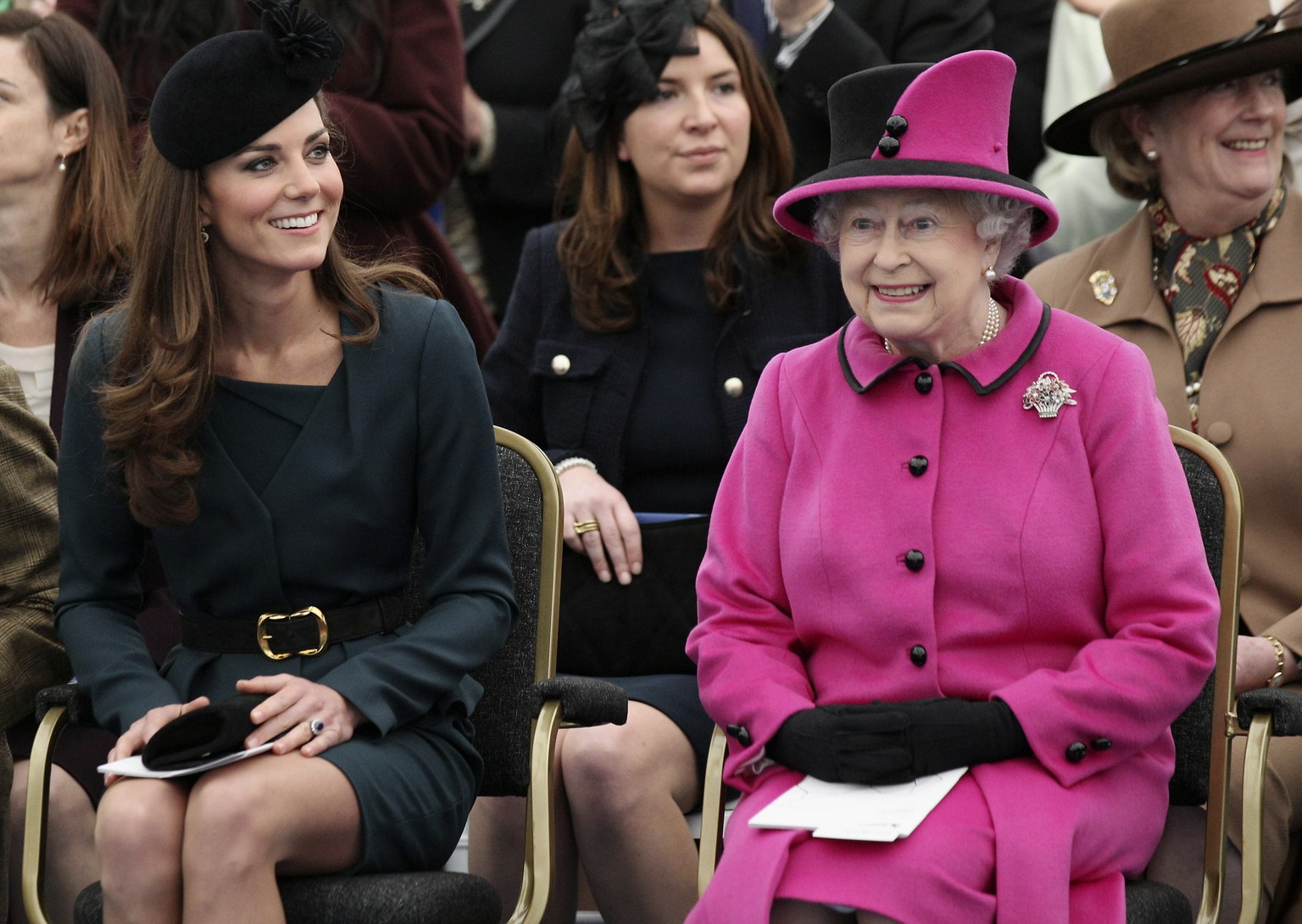 FILE - Britain&#039;s Queen Elizabeth II, right, and Catherine, Duchess of Cambridge watch a fashion show at De Montfort University in Leicester, England, Thursday March 8, 2012. (AP Photo/Oli Scarff, ...