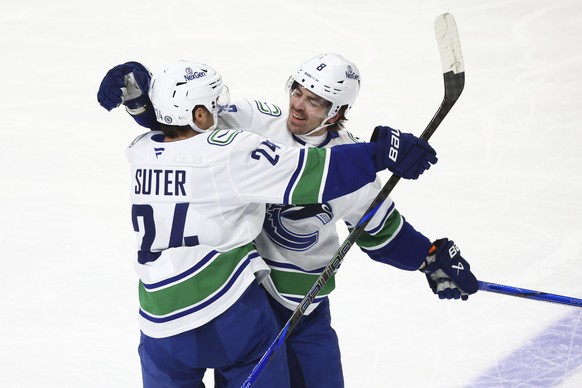 Vancouver Canucks center Pius Suter (24) celebrates after his goal with right wing Conor Garland (8) during the third period of an NHL hockey game against the Buffalo Sabres, Friday, Nov. 29, 2024, in ...