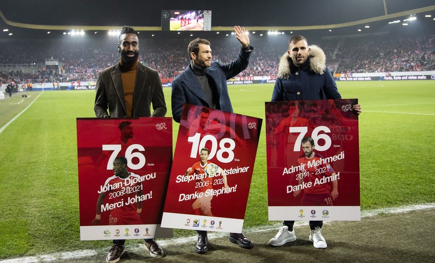 epa09583858 Former Swiss national soccer team players (L-R) Johan Djourou, Stephan Lichtsteiner, and Admir Mehmedi are celebrated after retirement prior to the FIFA World Cup 2022 group C qualifying s ...