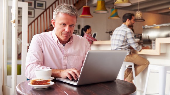 Middle-aged person working in a café