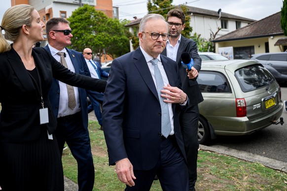 epa12595343 Australian Prime Minister Anthony Albanese (C) departs St George Hospital after visiting Ahmed al-Ahmed in Sydney, Australia, 16 December 2025. Australia is in mourning following an attack ...