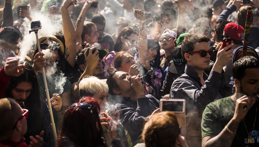 People gather to smoke marijuana during the &quot;420 Toronto&quot; rally in Toronto on Wednesday, April 20, 2016. Cannabis possession is illegal in most countries under a 1925 treaty called the Inter ...