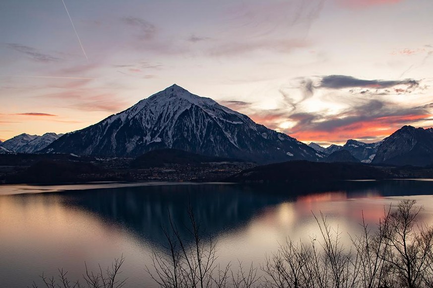 THUN, SWITZERLAND - JANUARY 15, 2019: The Niesen mountain overlooking Thun lake at sunset.