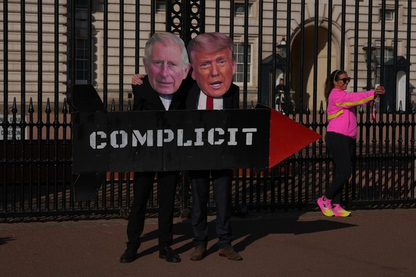Protesters from the Stop Trump Coalition, dressed as mock President Donald Trump and Britain's King Charles III and carrying a prop missile, demonstrate outside Buckingham Palace in London, Monda ...