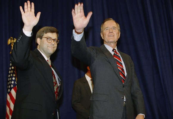 FILE - In this Nov. 26, 1991, file photo, President George H.W Bush, right, and William Barr wave after Barr was sworn in as the new Attorney General of the United States at a Justice Department cerem ...