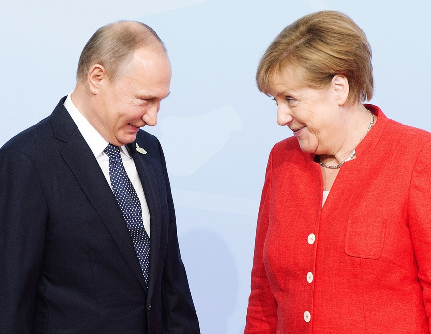 Russian President Vladimir Putin is greeted by German Chancellor Angela Merkel at the official welcoming ceremony at the G20 summit Friday, July 7, 2017 in Hamburg, Germany. (Remiorz/The Canadian Pres ...