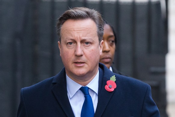 epa08807180 Britain&#039;s former Prime Minister David Cameron (L) walks through Downing Street to attend the National Service of Remembrance, on Remembrance Sunday, at The Cenotaph in Westminster, Lo ...