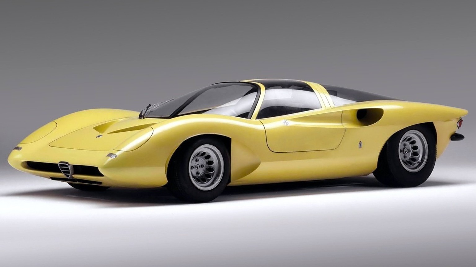 Alfa Romeo 33/2 Coupé Speciale, 1969: Designed by Leonardo Fioravanti for Pininfarina. Often overshadowed by the Carabo, this "fluorescent yellow" masterpiece features dramatic butterfly doo ...