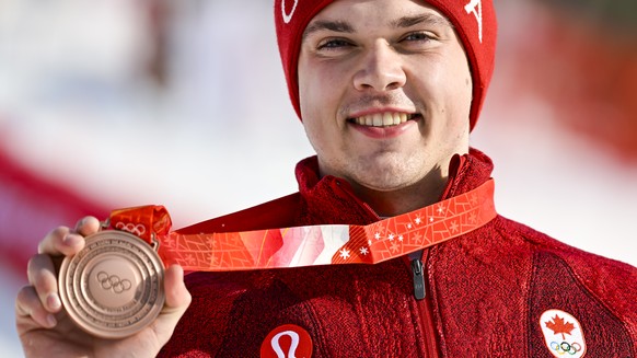 Bronze medalist James Crawford of Canada celebrates during the victory ceremony of the men&#039;s Alpine Skiing Combined Slalom at the 2022 Olympic Winter Games in Yanqing, China, on Thursday, Februar ...