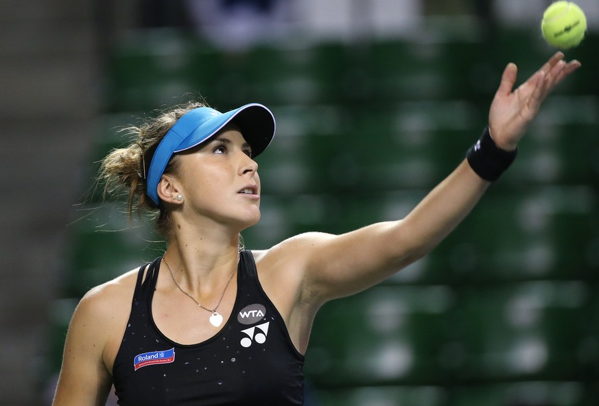 Belinda Bencic of Switzerland tosses a ball to serve against Garbine Muguruza of Spain during a quarterfinal match at the Pan Pacific Open womens tennis tournament in Tokyo, Friday, Sept. 25, 2015. ( ...