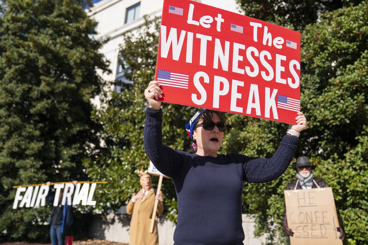 epa08108597 Laura Albinson with the Progressive Democrats of America participates at a small rally to urge action to 'impeach, remove, indict and jail' President Trump outside the Hart Senat ...