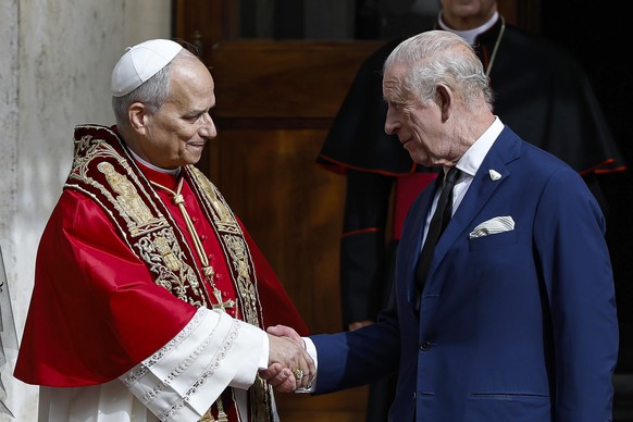 epa12475257 Pope Leo XIV (L) shakes hands with Britain&#039;s King Charles III (R) during the royal couple&#039;s state visit to Vatican City, 23 October 2025. EPA/ANGELO CARCONI