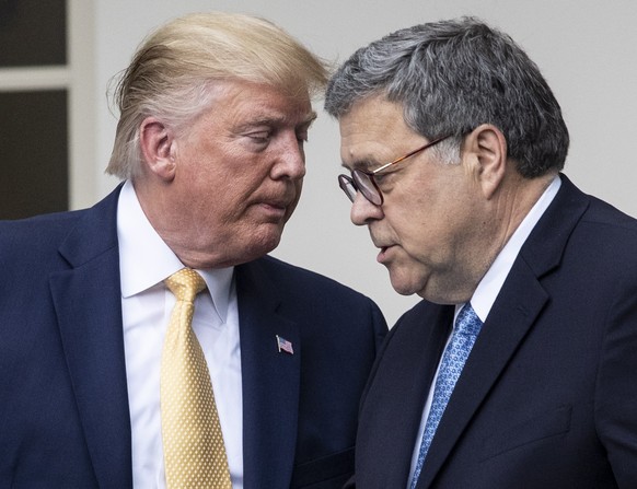 epa08939623 (FILE) US President Donald J. Trump (L) hands over the podium to US Attorney General William Barr (R) while participating in an announcement on US citizenship and the census, in the Rose G ...