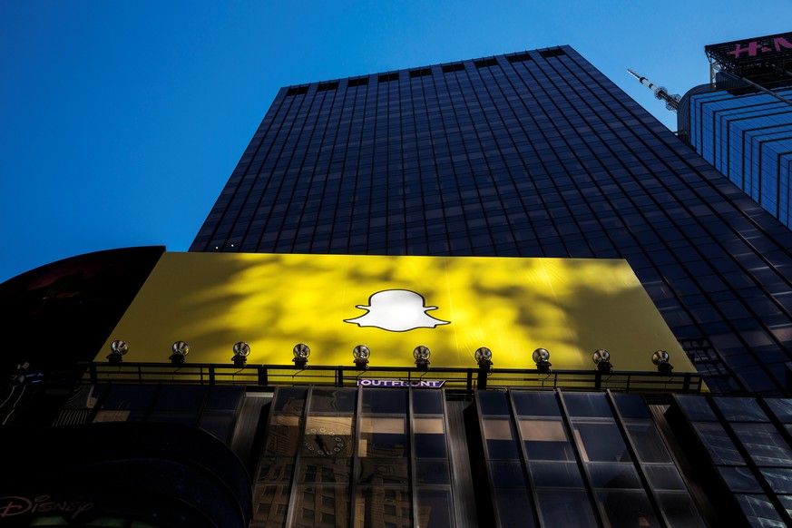 FILE PHOTO: A billboard displays the logo of Snapchat above Times Square in New York March 12, 2015. To match Analysis SNAP-IPO/HARDWARE REUTERS/Lucas Jackson/File Photo