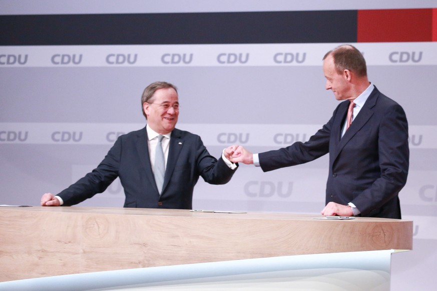 epa08941675 New chairman of the Christian Democratic Union of Germany (CDU) party, Prime Minister of North Rhine-Westphalia Armin Laschet (L) and Friedrich Merz (R) during a CDU party virtual party co ...