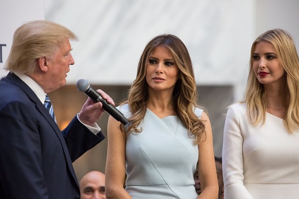In the grand lobby of Trump International Hotel, U.S. Presidential candidate Donald J. Trump (left) makes remarks with his wife Melania Trump, and daughter Ivanka Trump, by his side before the ribbon  ...