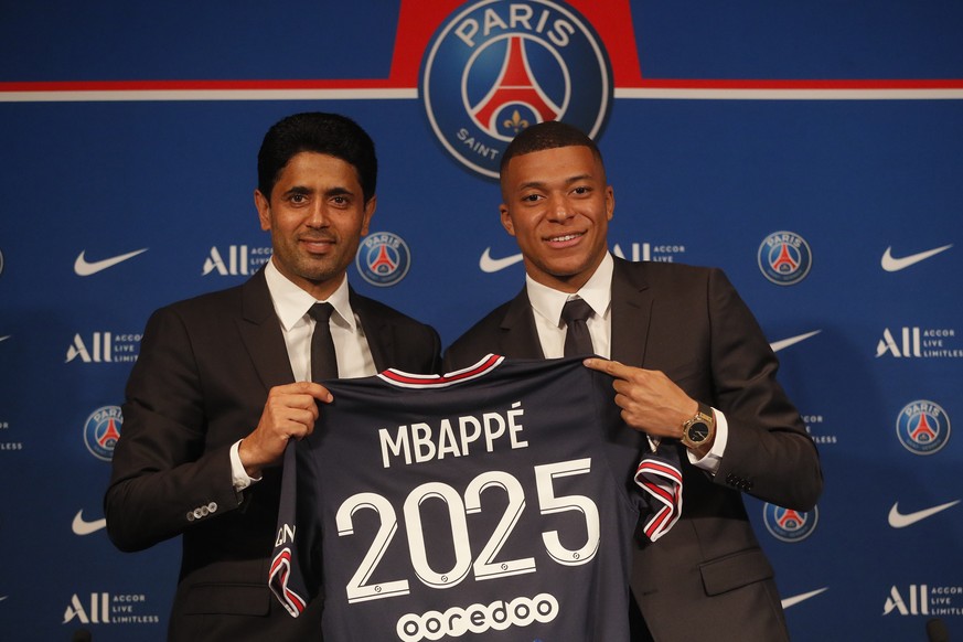 PSG striker Kylian Mbappe, right, shows his jersey with PSG president Nasser Al-Khelaifi during a press conference Monday, May 23, 2022 at the Paris des Princes stadium in Paris. Kylian Mbappé&#039;s  ...