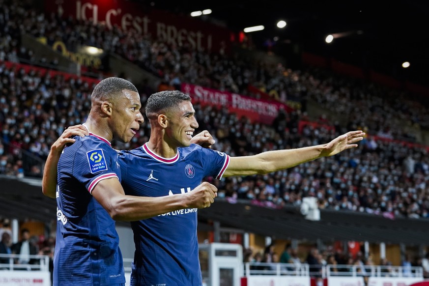 FILE - PSG&#039;s Kylian Mbappe, left, celebrates with teammate PSG&#039;s Achraf Hakimi after scoring his side&#039;s second goal during a French League One soccer match between Brest and PSG at the  ...