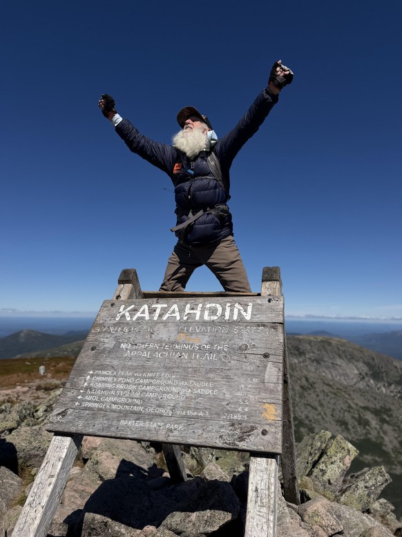 Dale Sanders, 91, celebrates upon completing his hike of the Appalachian Trail at the summit of Mt. Katahdin, Monday, Aug. 31, 2026 in Baxter State Park in Piscataquis County, Maine. (AP Photo/Robert  ...