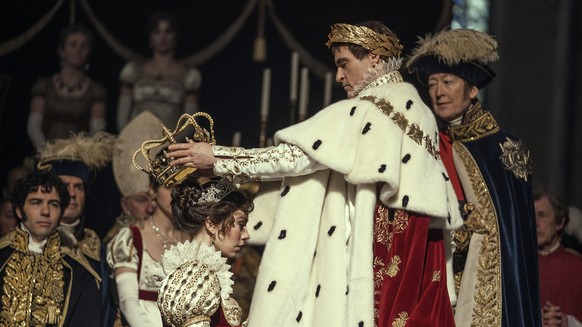 This image released by Apple TV+ shows Vanessa Kirby, foreground left, and Joaquin Phoenix in a scene from "Napoleon." (Aidan Monaghan/Apple TV+ via AP)