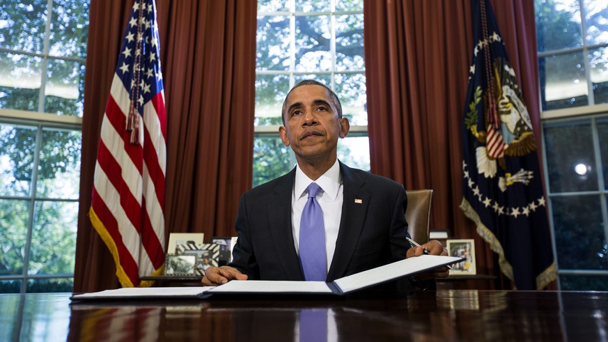epa04990026 US President Barack Obama vetoes the National Defense Authorization Act (NDAA), which authorizes spending for the Defense Department, in the Oval Office of the White House in Washington, D ...