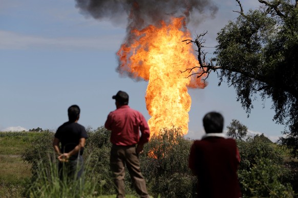 epa07847135 View of a fire-column coming from a leaking pipeline, in Puebla, Mexico, 16 September 2019. Six workers of the Pemex company have been reported injured when they were working on controllin ...