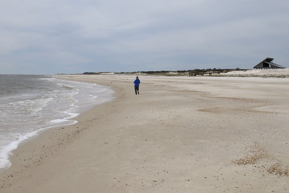 FILE - In this Feb. 5, 2007, file photo, miles of empty beach and billions of sea shells await a lone beachcomber at St. George Island State Park near Apalachicola in the Florida Panhandle on Feb. 5,  ...