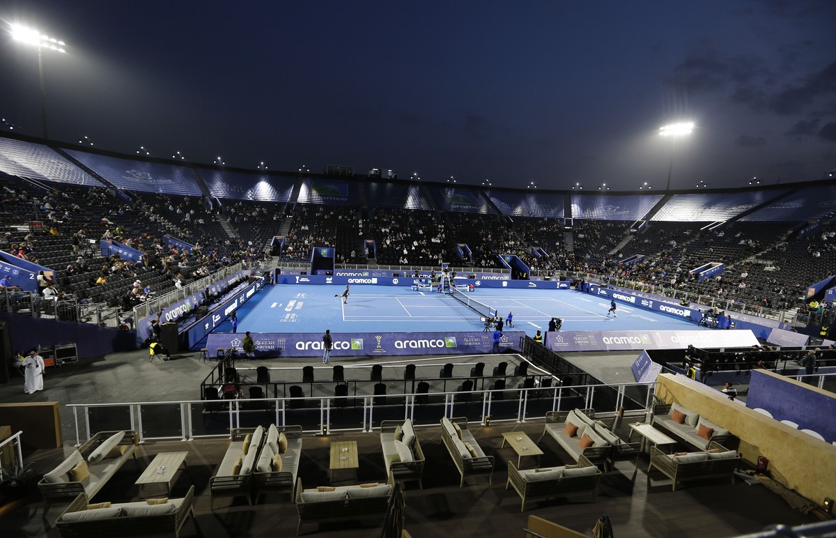 FILE - Fabio Fognini, of Italy, left, plays against Gael Monfils, of France, at the Diriyah tourist site in Riyadh, Saudi Arabia, Dec. 13, 2019. Saudi Arabia's Public Investment Fund and the men& ...