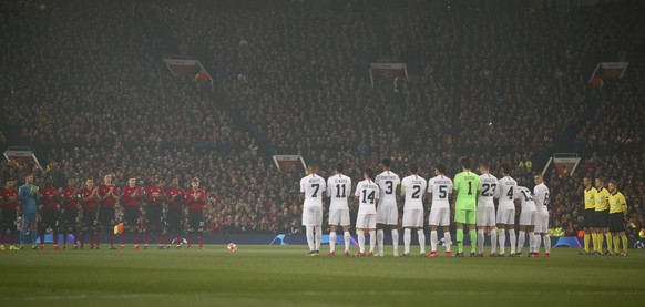 Manchester United and Paris Saint Germain line up as they applaud the memory of former England goalkeeper Gordon Banks who has died, before the start of the Champions League round of 16 soccer match b ...
