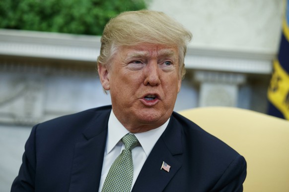 FILE - In this March 15, 2018, file photo, President Donald Trump talks with reporters during a meeting in the Oval Office of the White House in Washington. Trump is questioning the impartiality of Ro ...